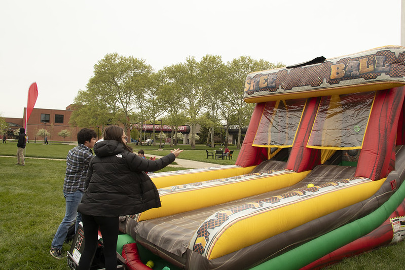 Two students playing skee ball.